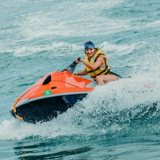 Lady riding a jet ski on the beach near Playa Blanca