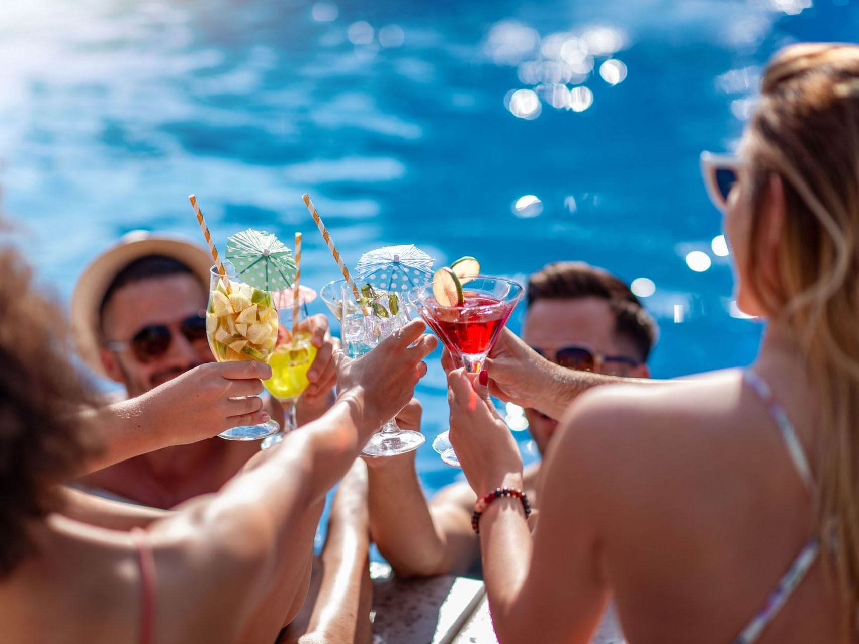 People cheering with cocktails at Metropolitan Al Mafraq Hotel