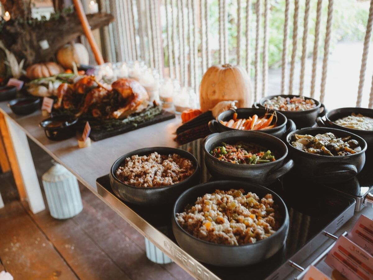 Bowls of colorful side dishes arranged along a buffet table.