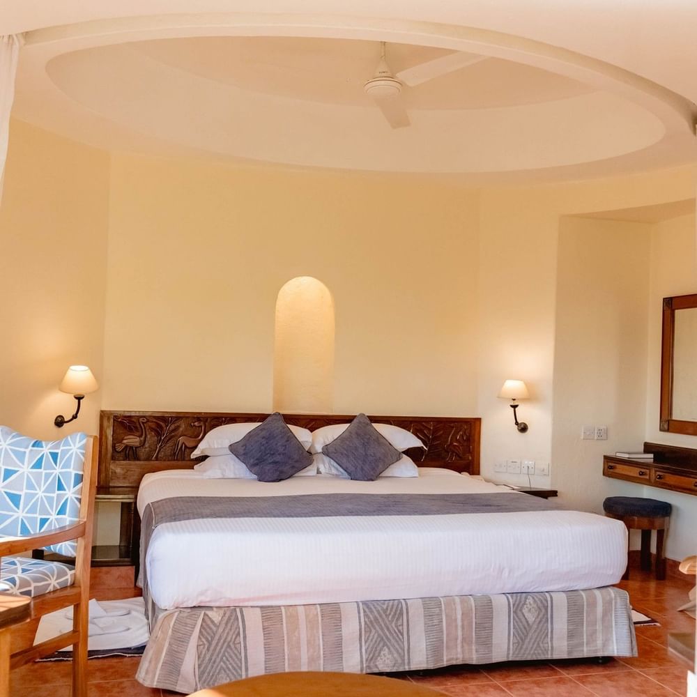 Cozy Standard King Room with elegant decor and modern amenities at Arusha Serena Hotel.