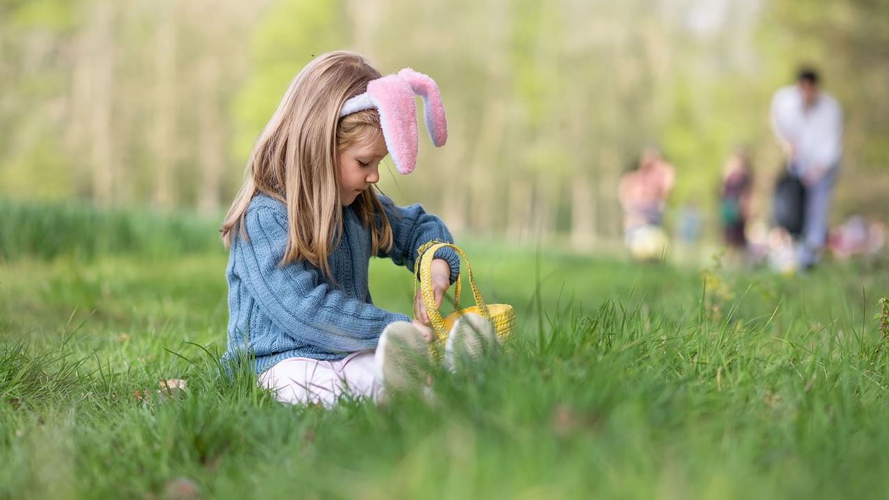 girl with bunny ears Easter egg hunting