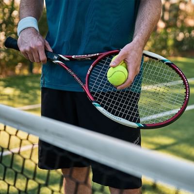 Tennis player with a racket & ball at Falkensteiner Hotels