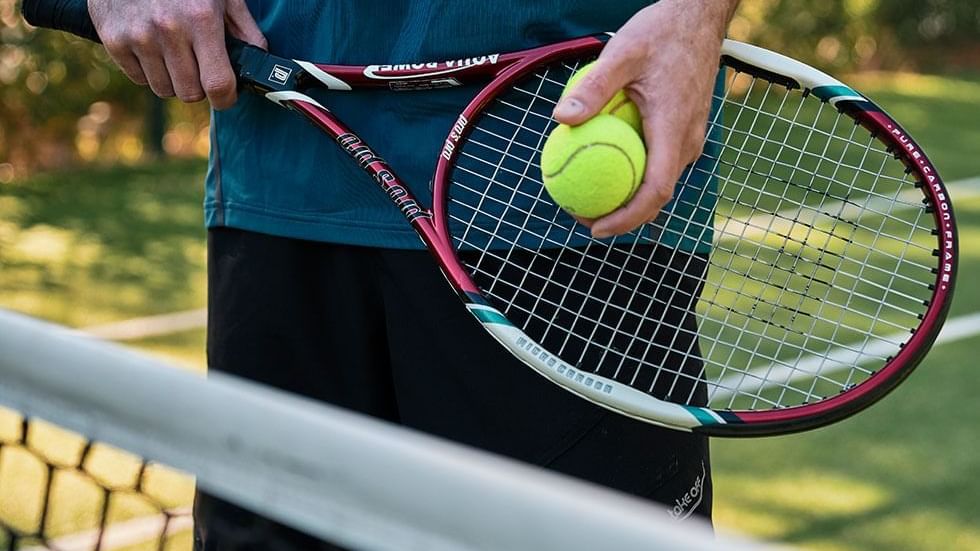 Tennis player with a racket & ball at Falkensteiner Hotels