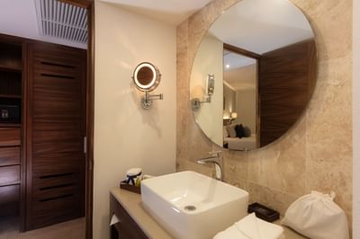 Bathroom with sink and round mirror of Family Deluxe Room at Buenaventura Grand Hotel and Spa