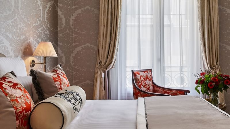 Deluxe Belle-Époque Suite with queen bed and comfy armchair by the window at Hôtel Westminster - Paris