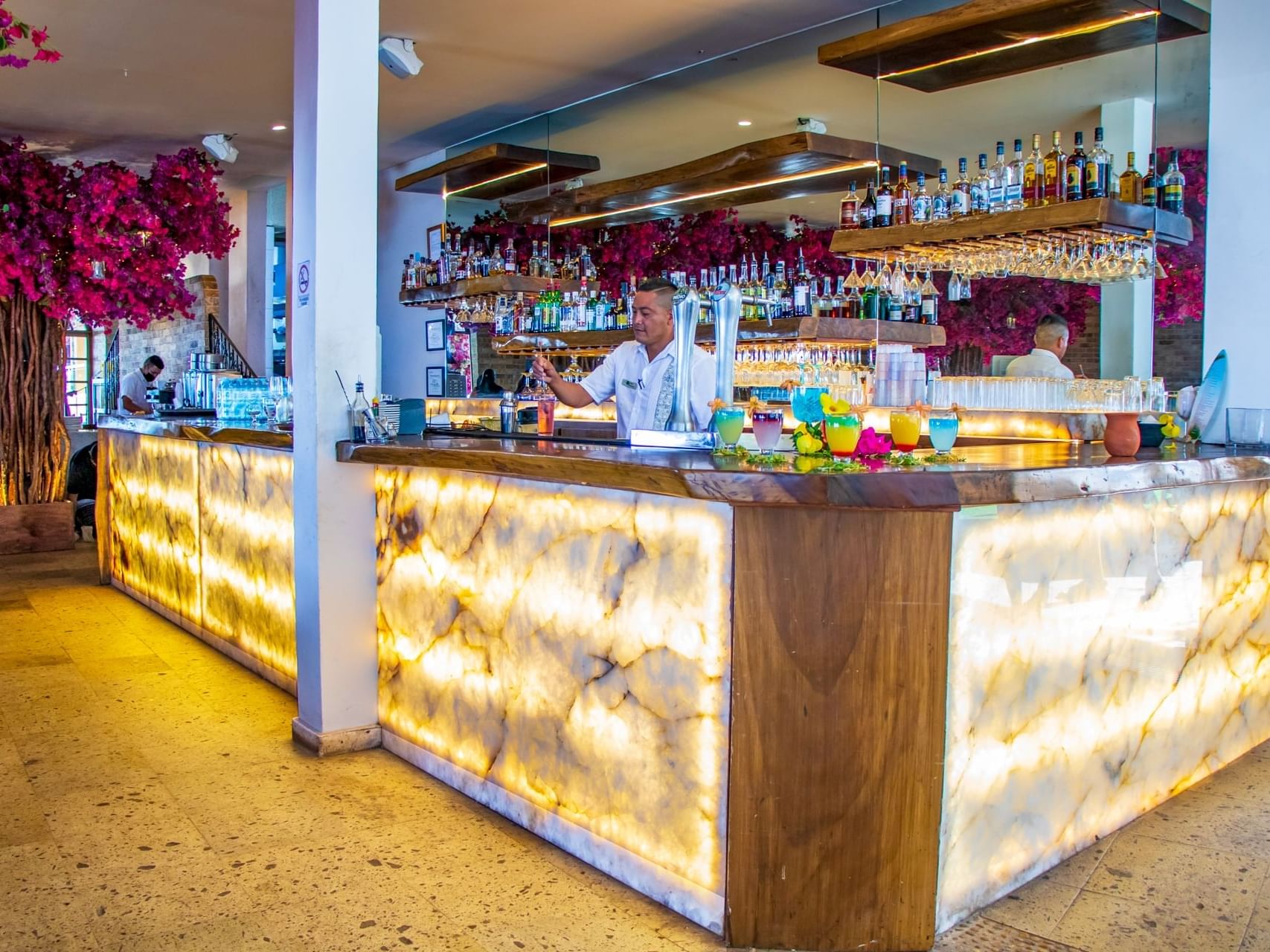 Bartender by the counter in Bar Tlaloc at Los Arcos Suites