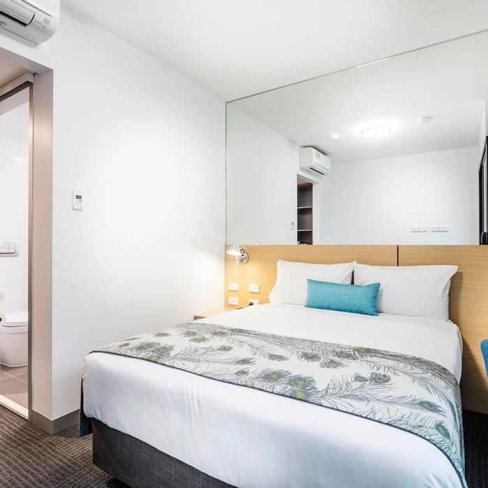 Bed & furniture in a Territory room at Darwin Airport Hotels