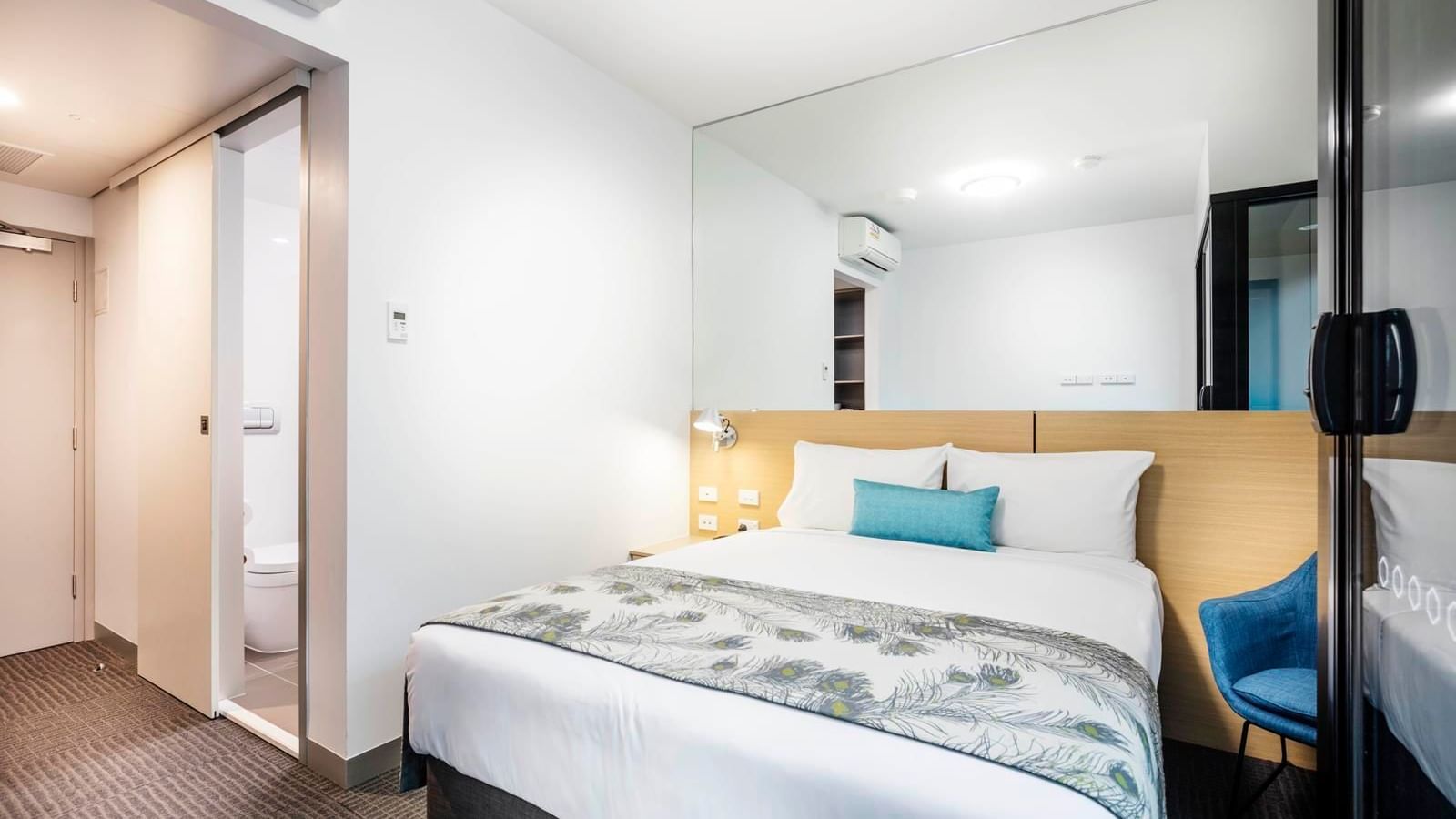 Bed & furniture in a Territory room at Darwin Airport Hotels