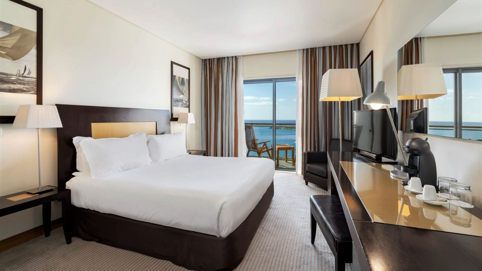 King bed, coffee station, lamps, TV & balcony with ocean view in Executive Ocean View Room at Hotel Marina Atlântico