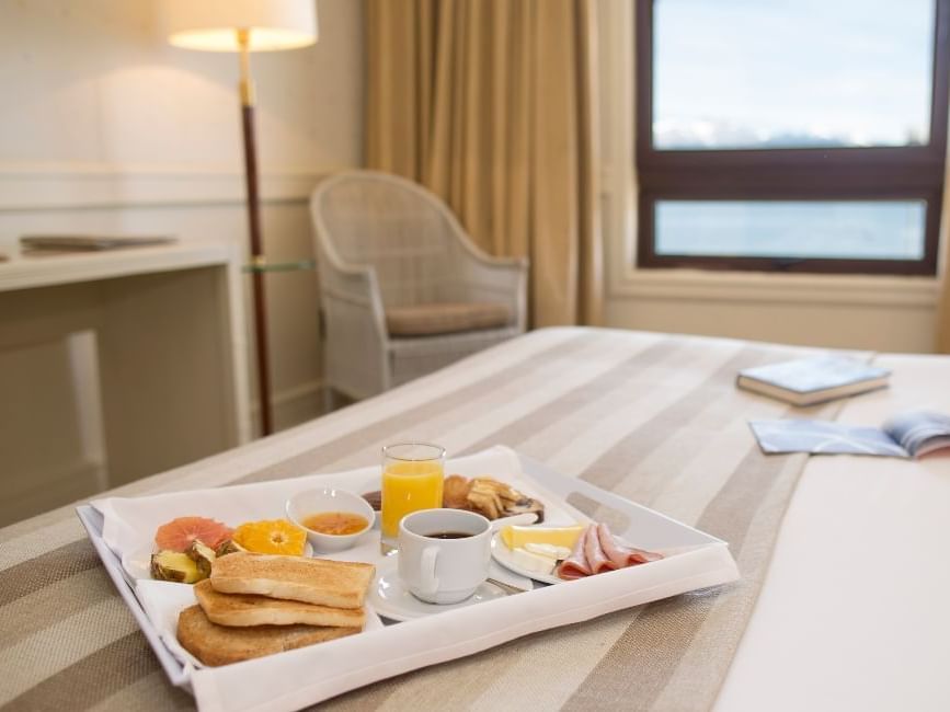 Breakfast tray on bed in essentials room at Hoteles Australis
