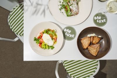 Salad & meat served in Bar Luxe at Sunset Blvd at Luxe Sunset Boulevard Hotel