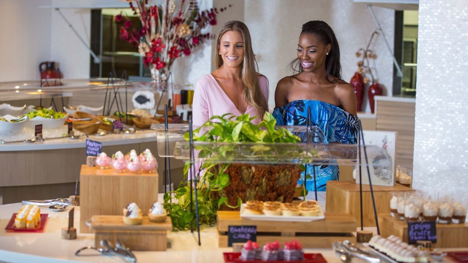 Two women stand by an Easter brunch buffet at Warwick Paradise Island in Nassau.