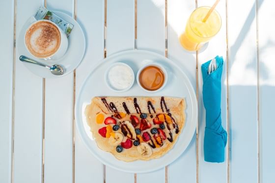 Breakfast with coffee and fresh juice served on the deck at Passions on the Beach