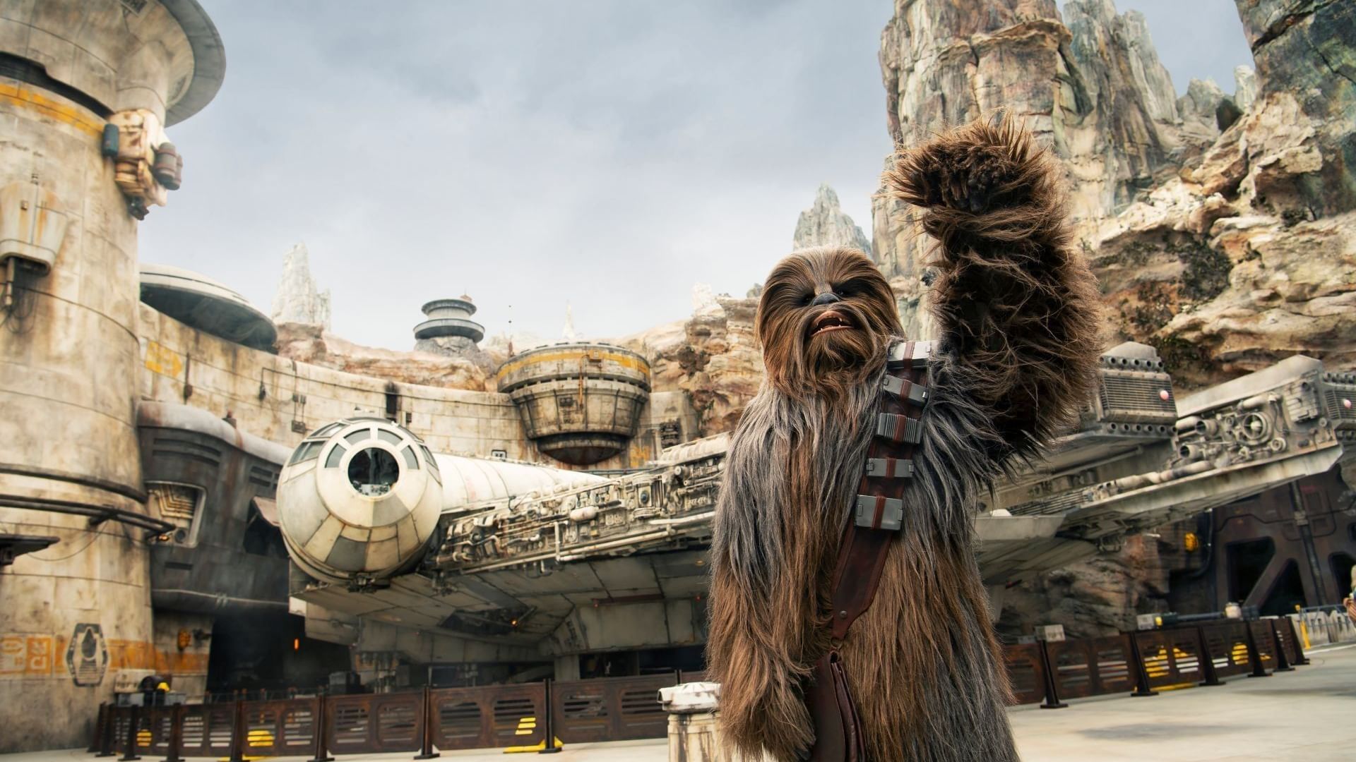 Chewbacca waving in front of a spaceship at May the 4th be with you event.