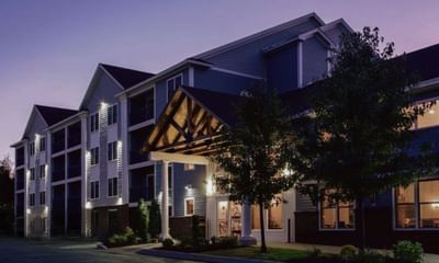 Exterior view of illuminated White River Inn and Suites, one of the best hotels in white river Jct, VT