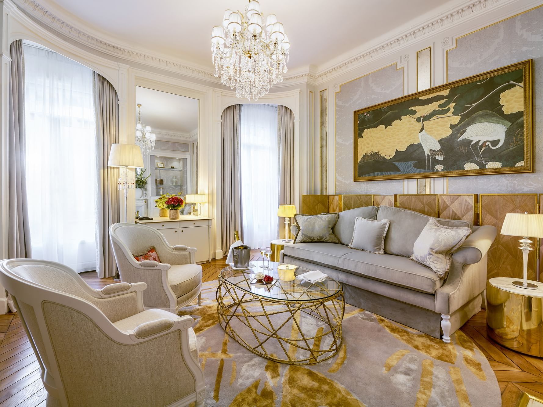 Duke of Westminster Suite living room featuring a plush sofa, armchairs, and a chandelier at Hôtel Westminster - Paris