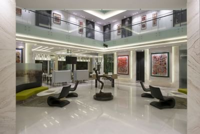 Modern lobby area with loft chairs & sculpture decor at Eastin Residences Vadodara