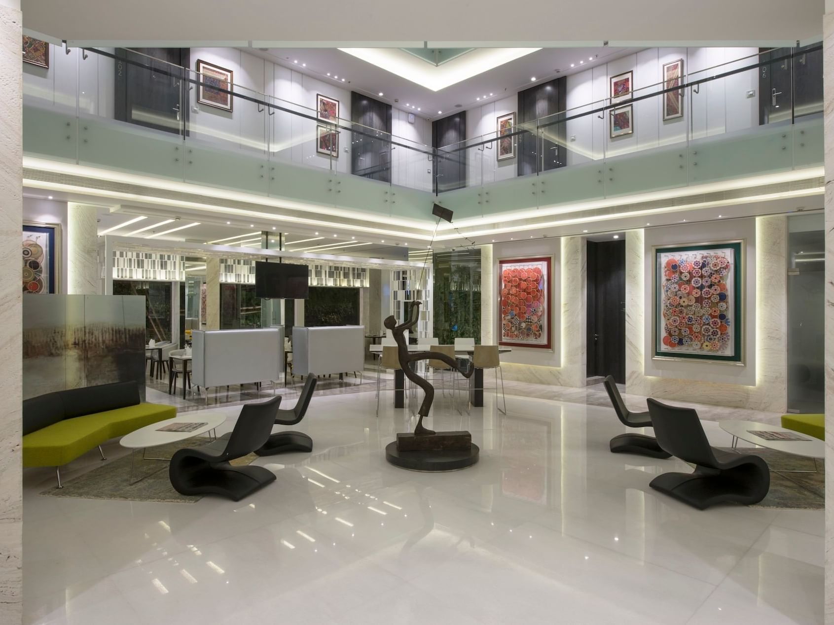Modern lobby area with loft chairs & sculpture decor at Eastin Residences Vadodara