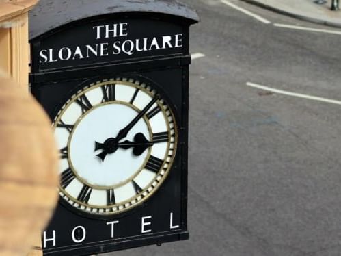 Hotel name board with clock at Sloane Square Hotel
