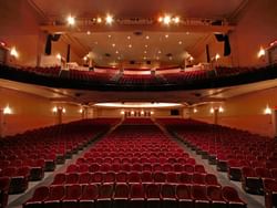 Interior of Theatre St-Denis with red chairs near Hotel Zero1