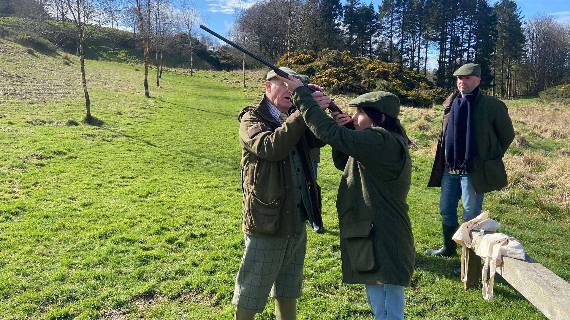 Three individuals in courts with shotguns in a grassy field, things to do in St Andrews near Seaton House