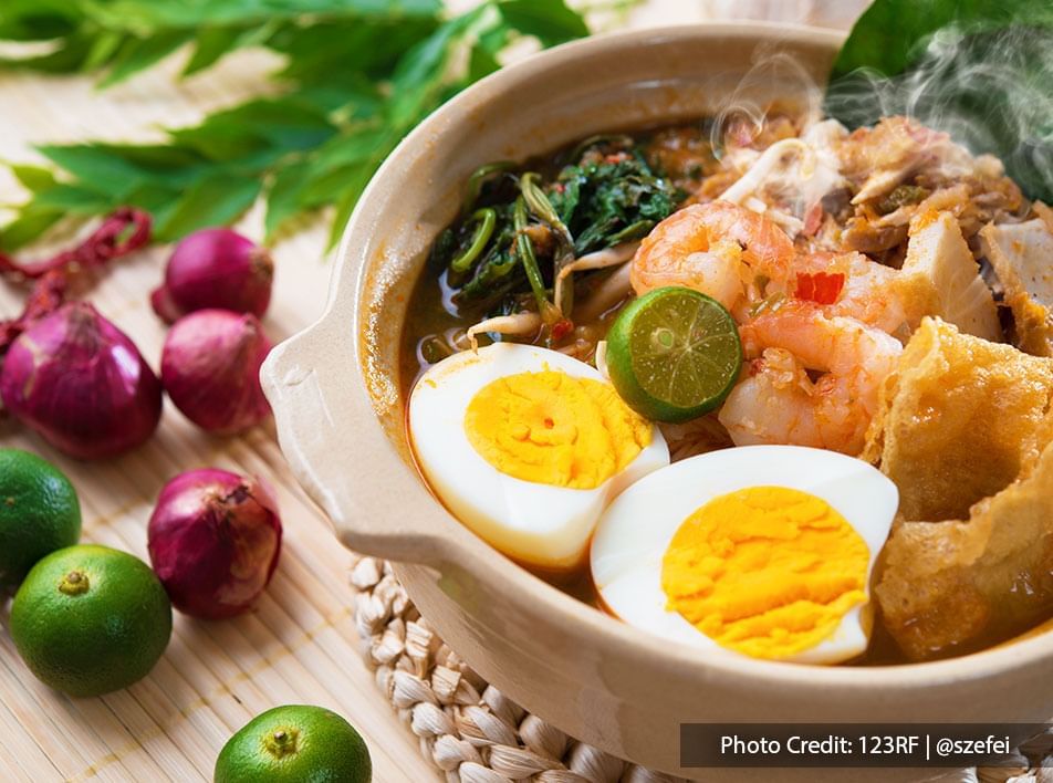 Penang Hokkien Mee or Prawn Mee is a spicy noodle soup dish topped with bean sprouts, water spinach, eggs, prawns, pork, and sambal