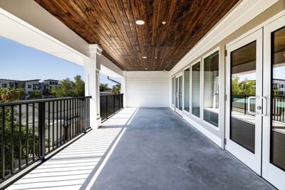 Balcony with white doors and wood ceiling at Grant Street Inn in Dunedin FL