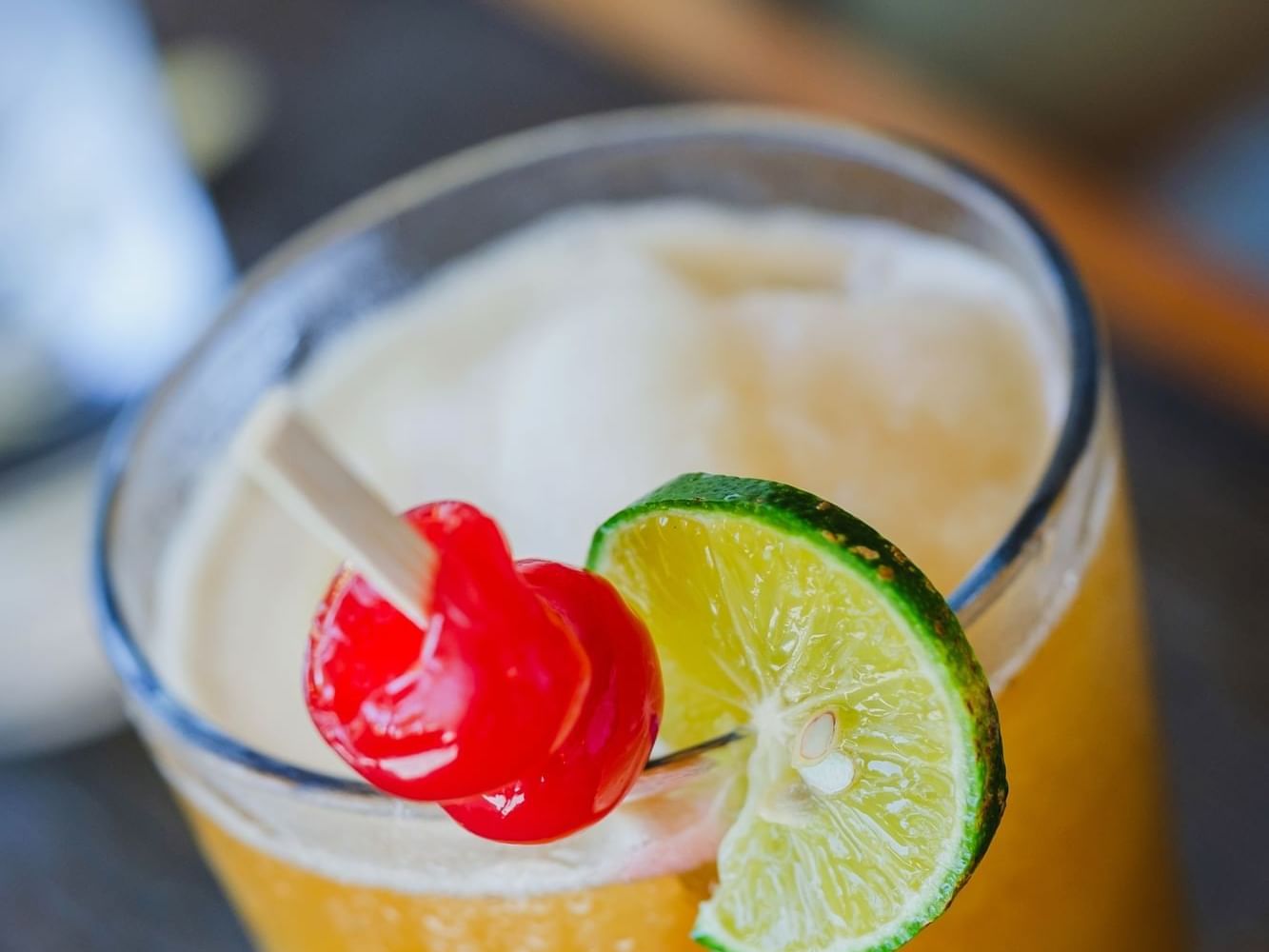 Close-up of a cocktail garnished with a lime slice in La Barqueta Poolside Bar & Grill at Las Olas Beach Resort