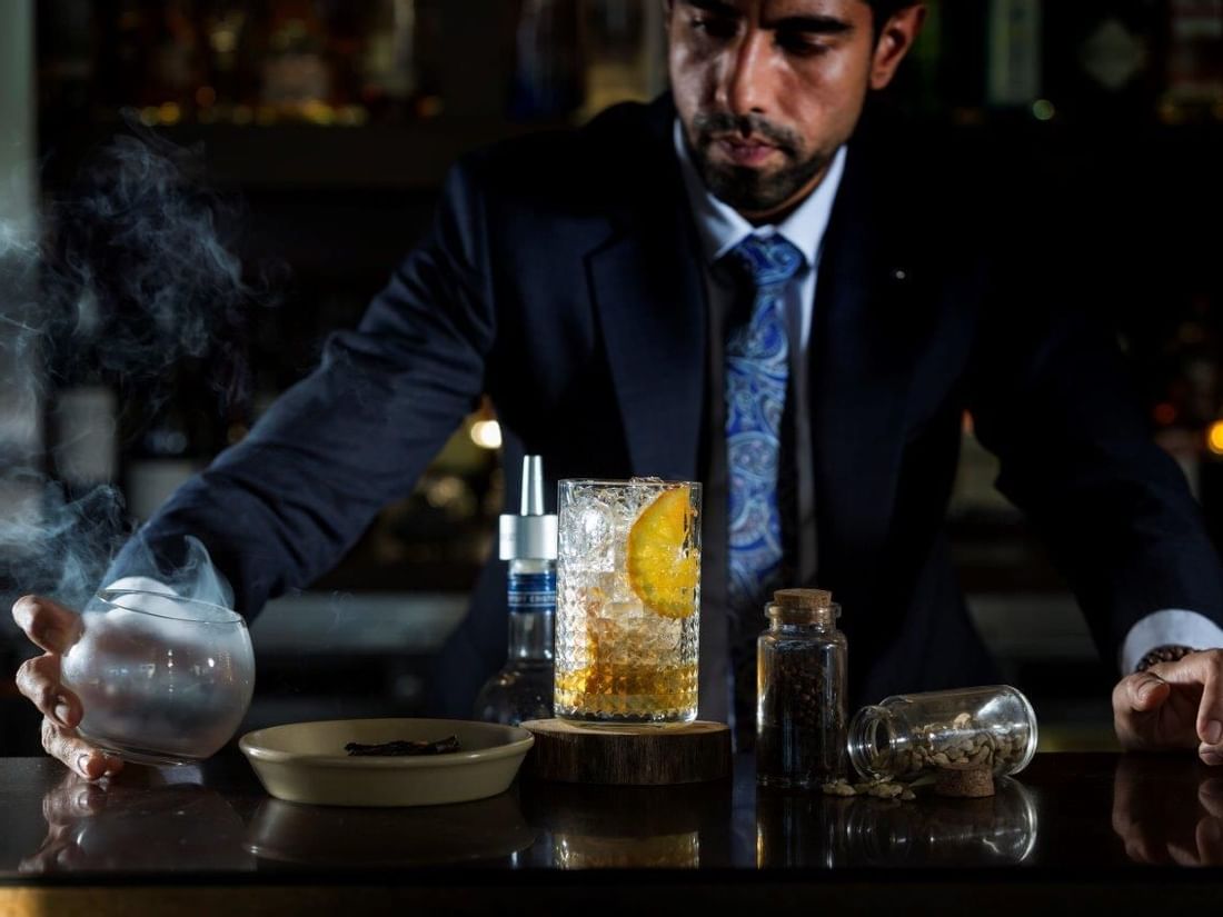 Bartender by the counter in Bacar Bar at Pullman Olympic Park 