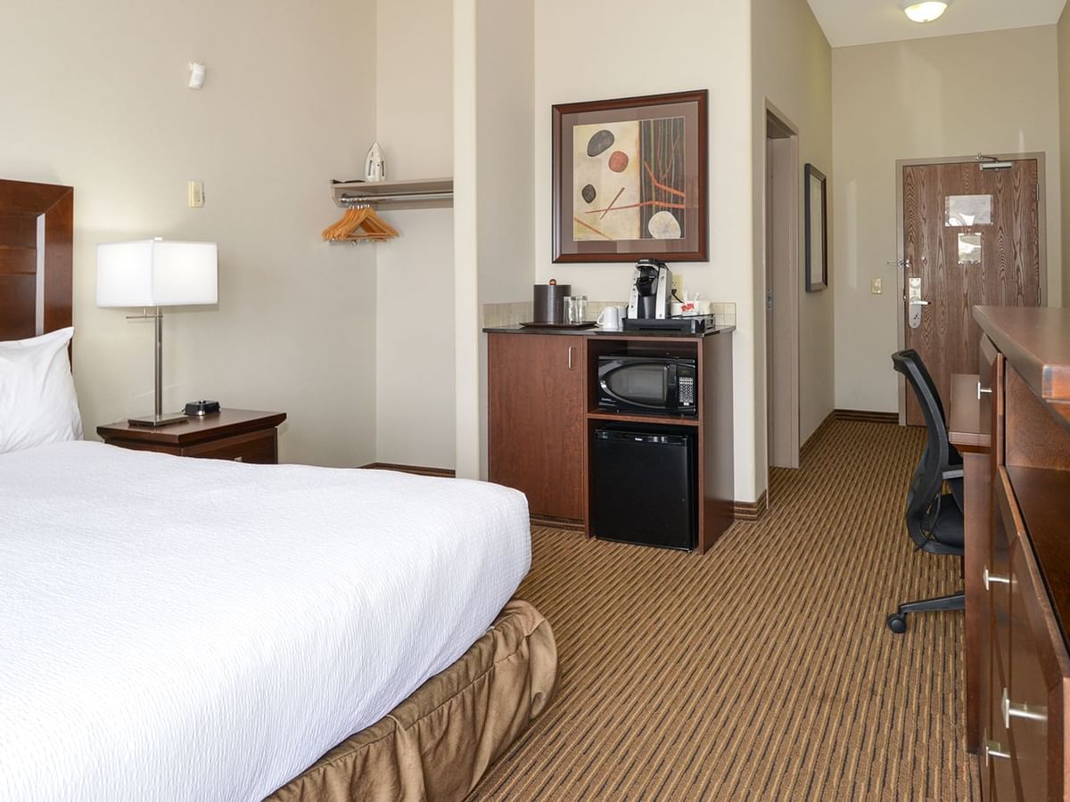 Accessible hotel room with king bed, mini fridge, coffee machine, work desk and chair