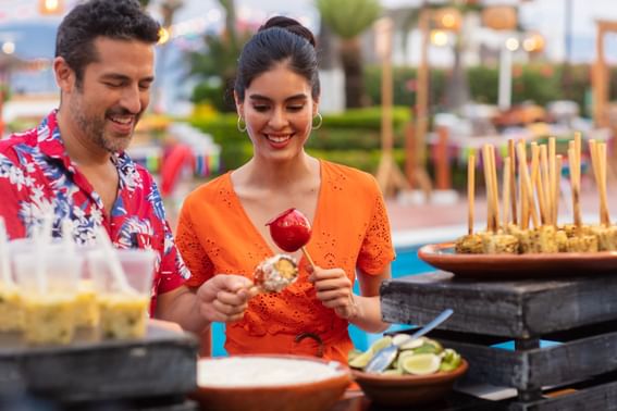 Couple enjoying a buffet with traditional dishes at Buenaventura Grand Hotel and Spa