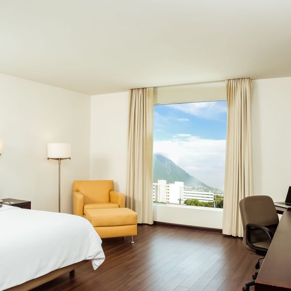 King bed in Superior Room with working desk at Fiesta Inn