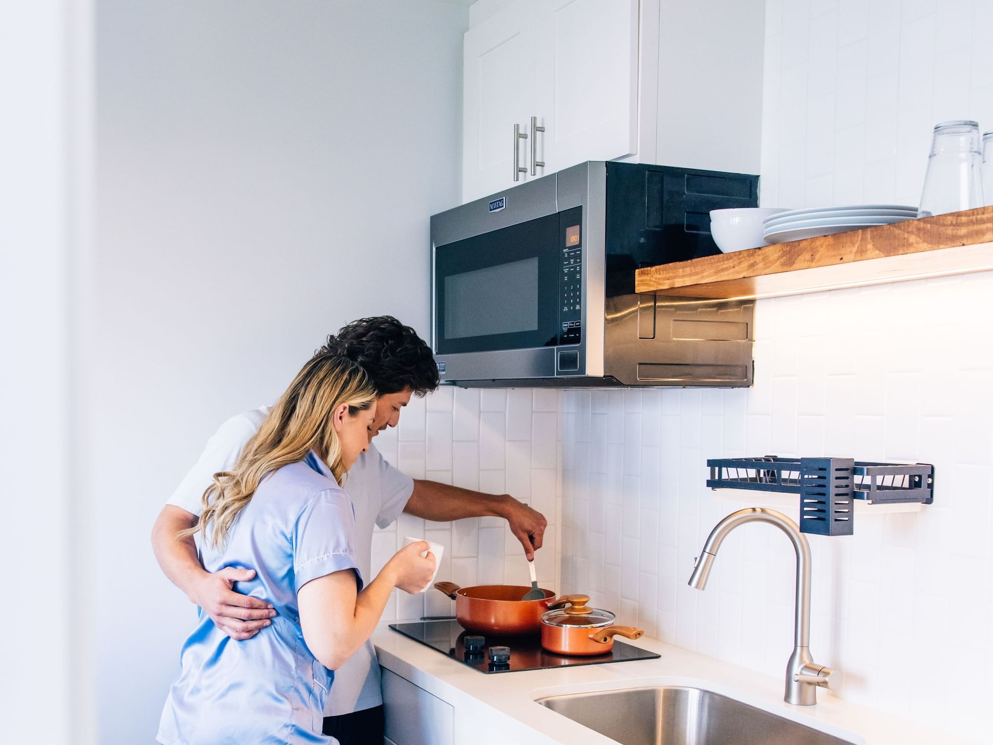 Couple cooking in the kitchen of a Garden Room with King Bed & Kitchen at Bayside Hotel Santa Monica.