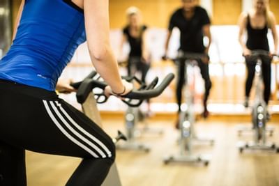 Knee-level shot of a lady on a stationary bicycle at Liebes Rot