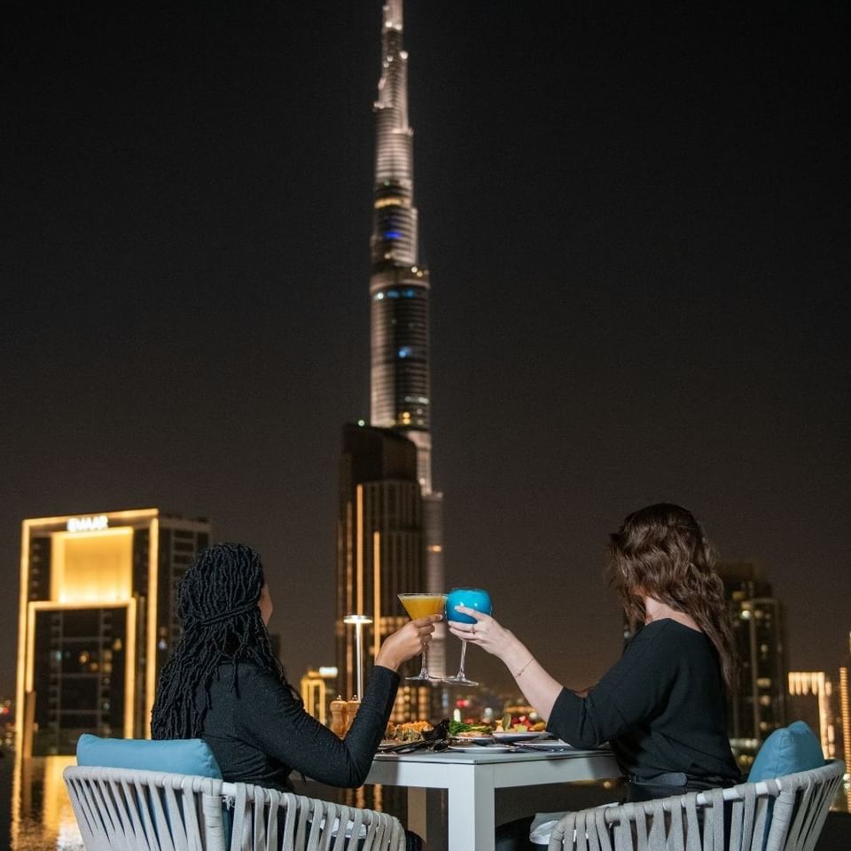 Two women having cocktails during the After Dark Friday Brunch near Burj Khalifa at Terrace Lounge in Malibu Sky Lounge & Bar