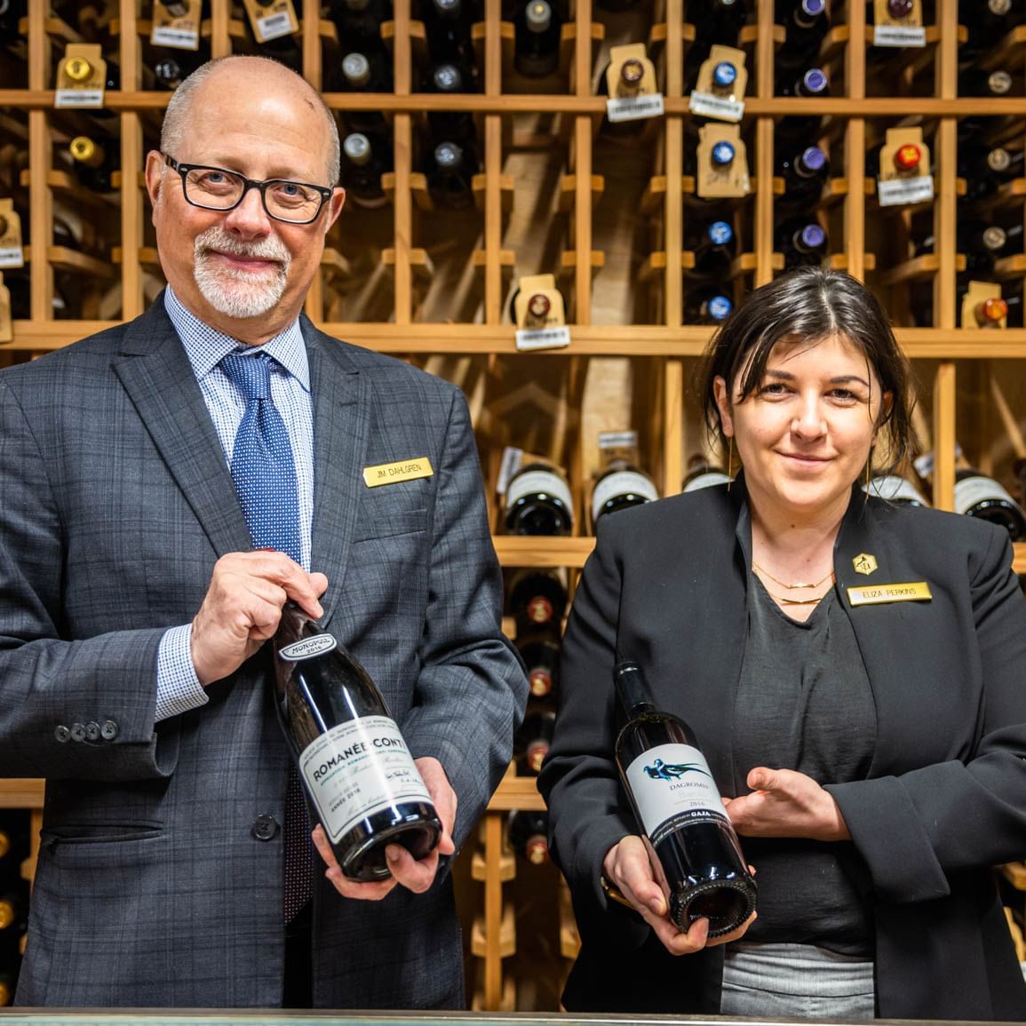 Portrait of two bartenders with wine bottles in Wine Cellar at Stein Eriksen Lodge