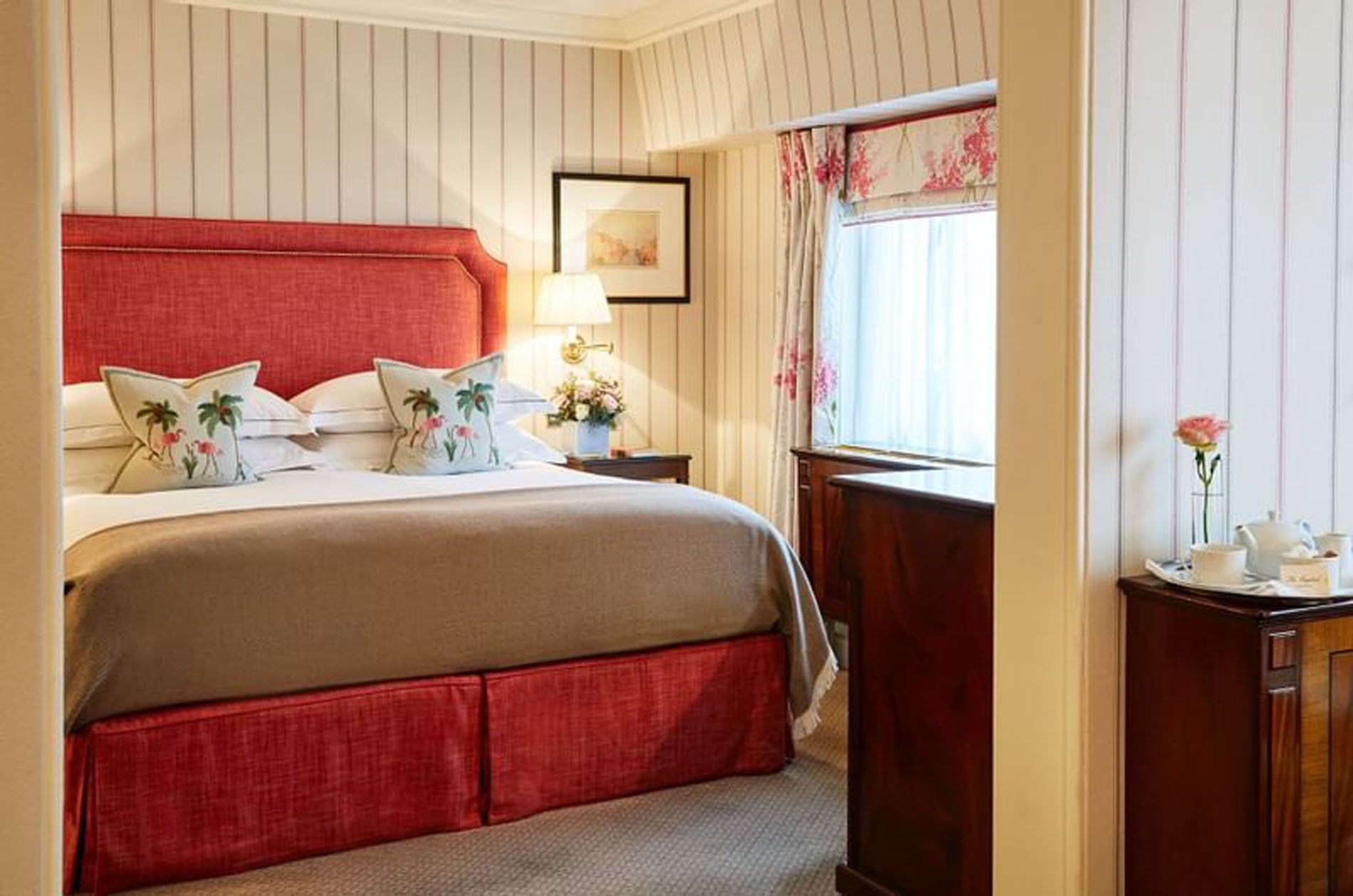 Bed with side tables near window in Junior Suite at The Capital Hotel, Apartments and Townhouse