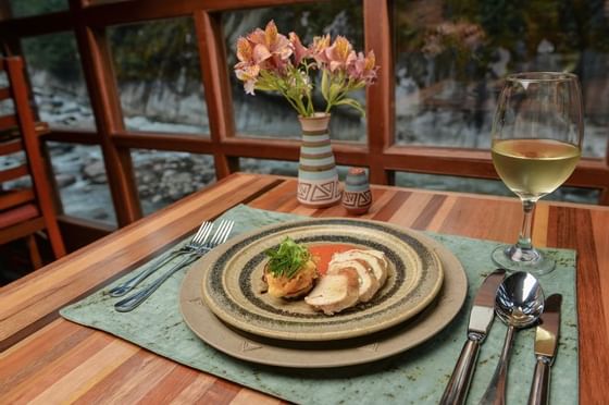 dining table with plate of food and wine glass cusco peru