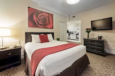 King bed in a room with a large rose painting at Artmore Hotel