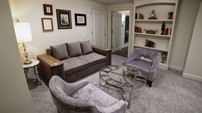 suite with couch and cozy carpet