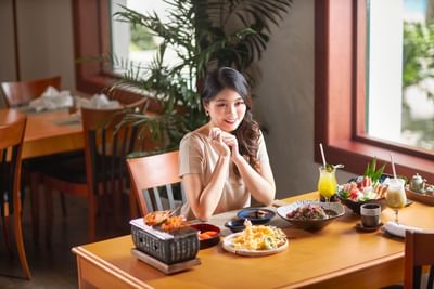 Lady served a cuisine in the Restaurant at Hanoi Daewoo Hotel
