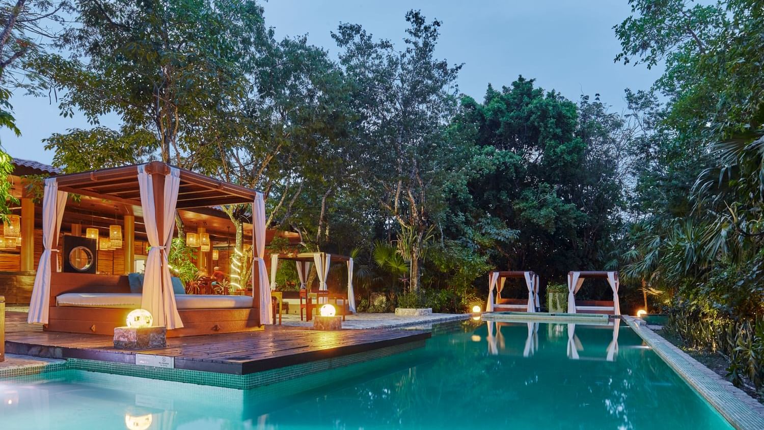 Relaxing cabanas arranged by the outdoor pool area at The Explorean Cozumel