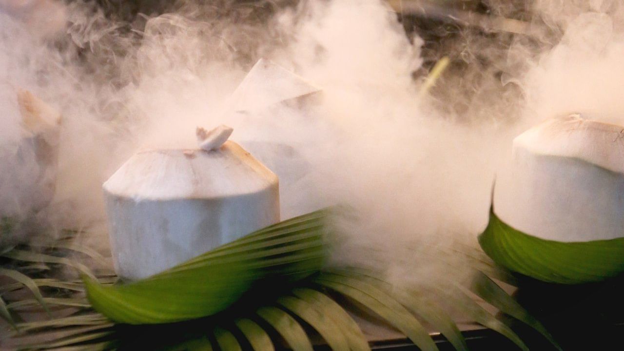 Tropical drinks station with steaming coconuts, creating a unique visual effect at Warwick Hotels and Resorts