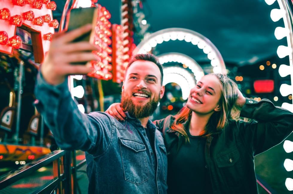 couple taking selfie at amusement park