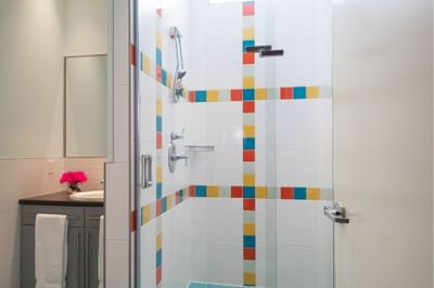 Bathroom vanity & shower area in King Superior South Beach at Retro Suites Hotel