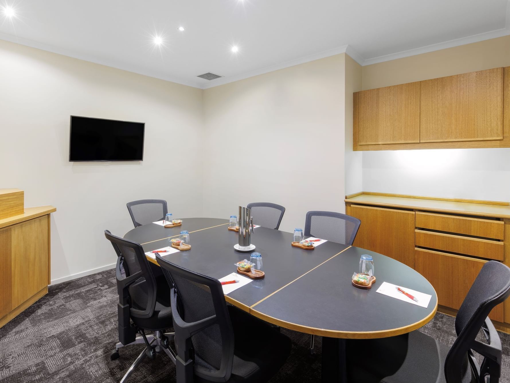 Oval table in Chancellor One boardroom set-up at Hotel Grand Chancellor Melbourne