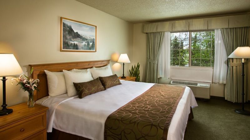 Bed in hotel room with window