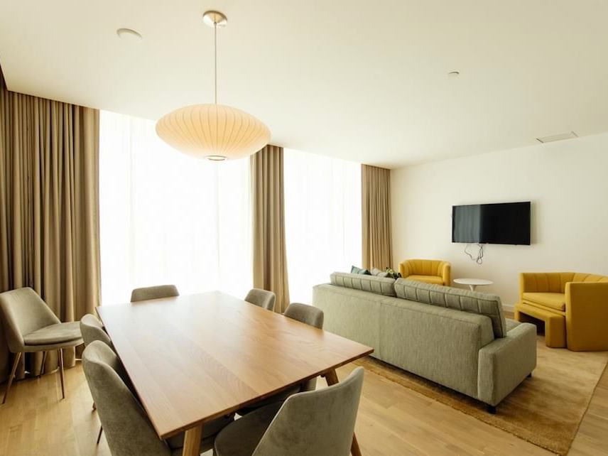 living room and dining room with television on wall