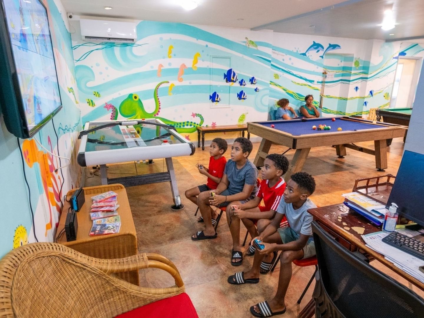 Children playing video games in a themed game room at Savannah Beach Hotel.
