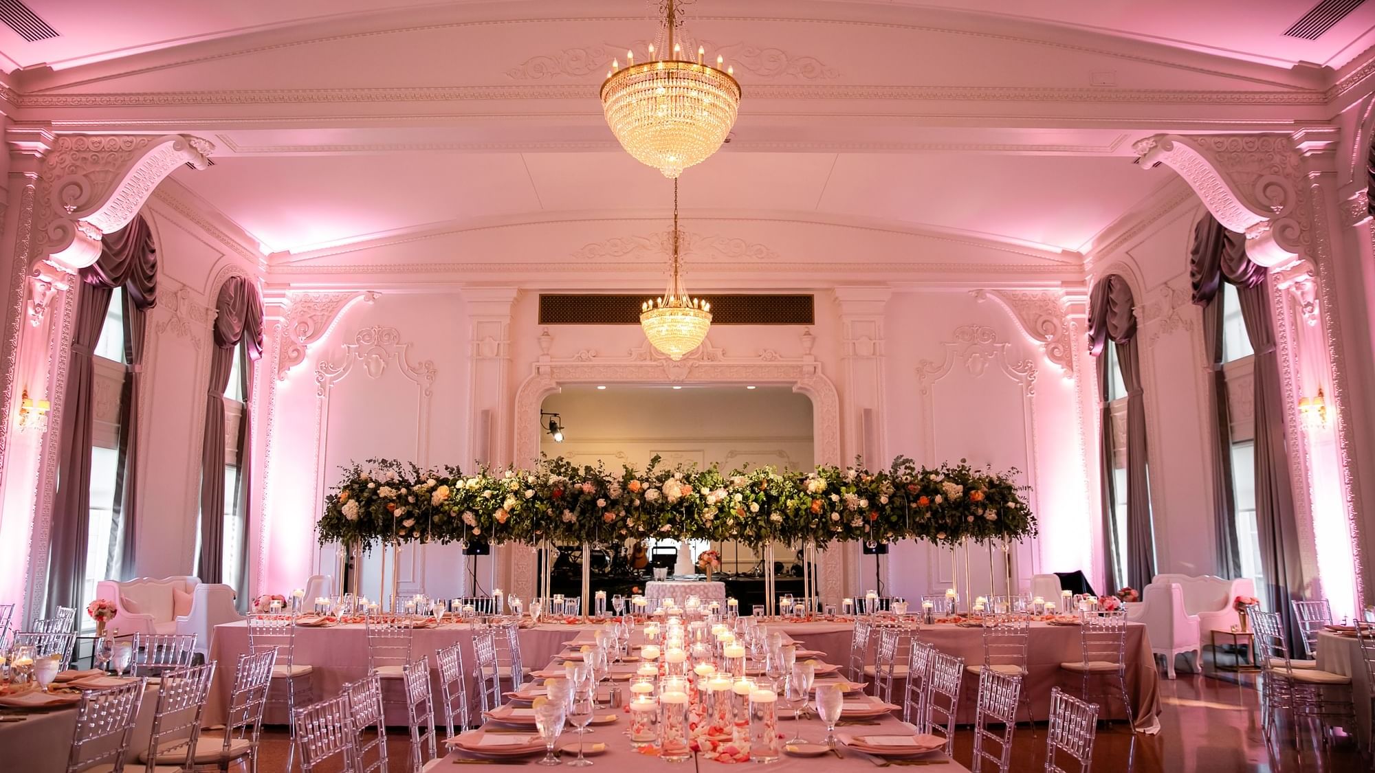 Elegantly decorated Crystal Ballroom with floral centerpieces and chandeliers at The Mayo Hotel in Tulsa.